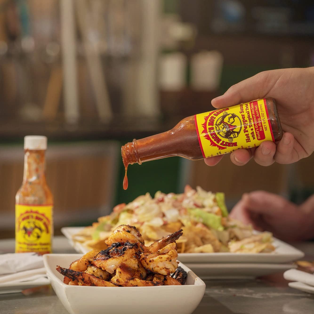 Dirty Dicks Original Hot Sauce on a wood table with kitchen vibe