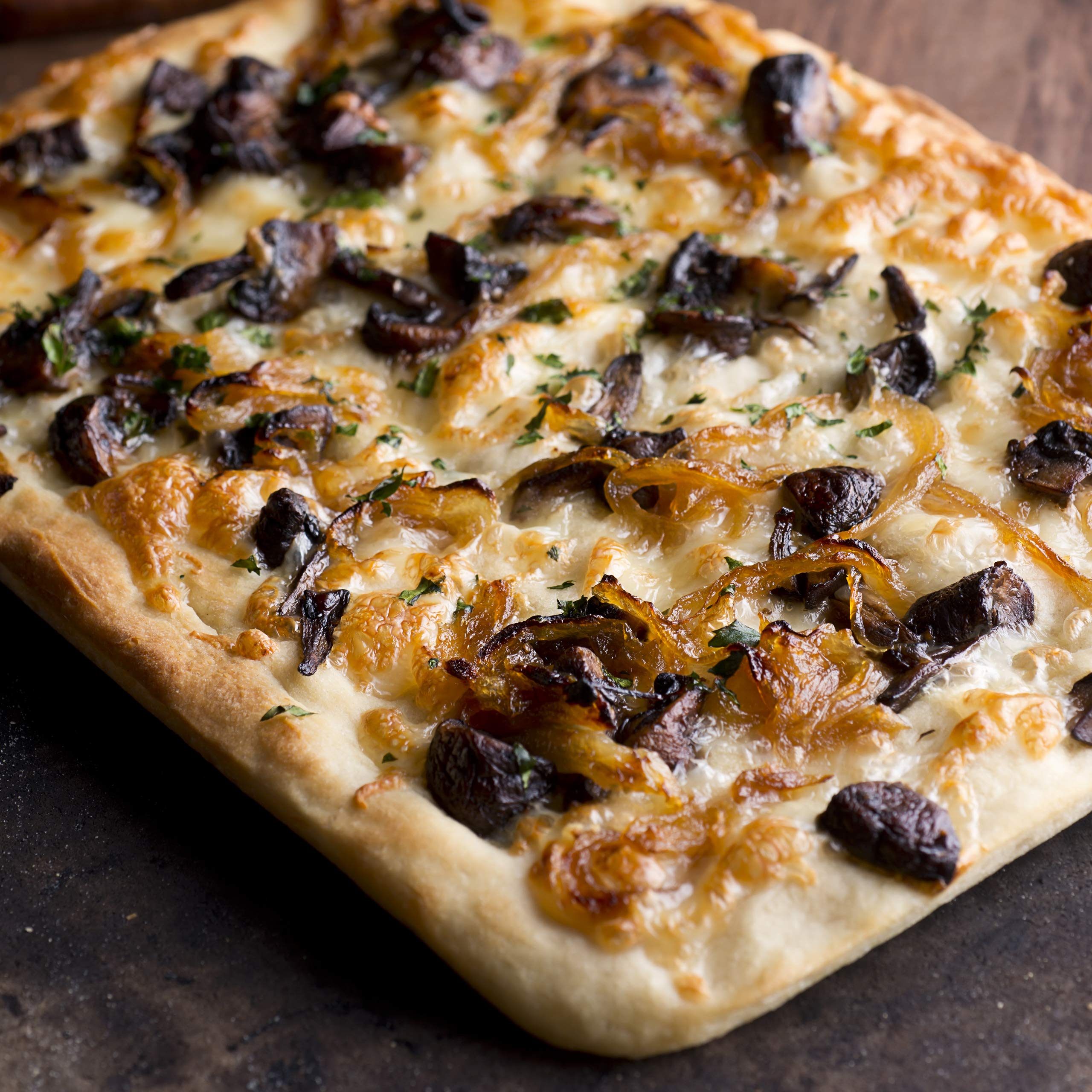 Divina onion jam with goat cheese on flatbread creates gourmet bites.