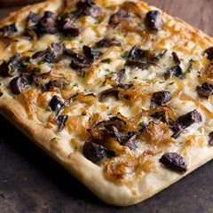 Divina onion jam with goat cheese on flatbread creates gourmet bites.