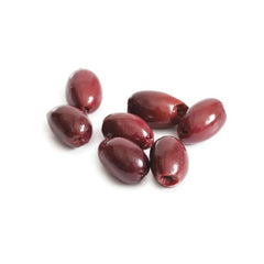 Divina Kalamata olives on a plate revealing smoky, fruity notes for pasta or pizza.