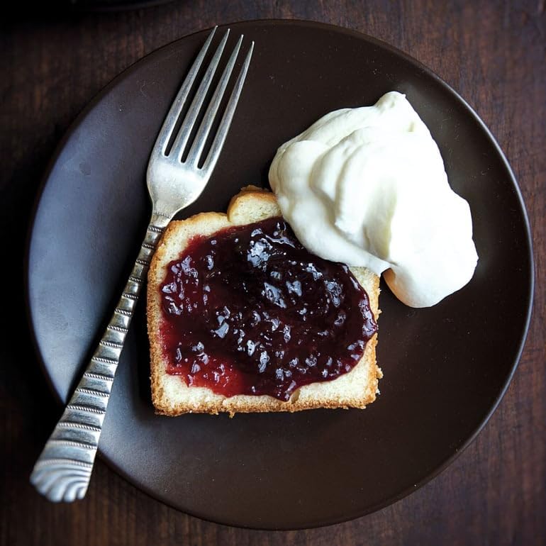 Open jar shows ruby jam, perfect for tasting and recipe ideas.