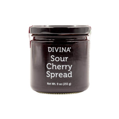 Divina sour cherry spread jam jar shows rich ruby color, perfect for cheese pairing.