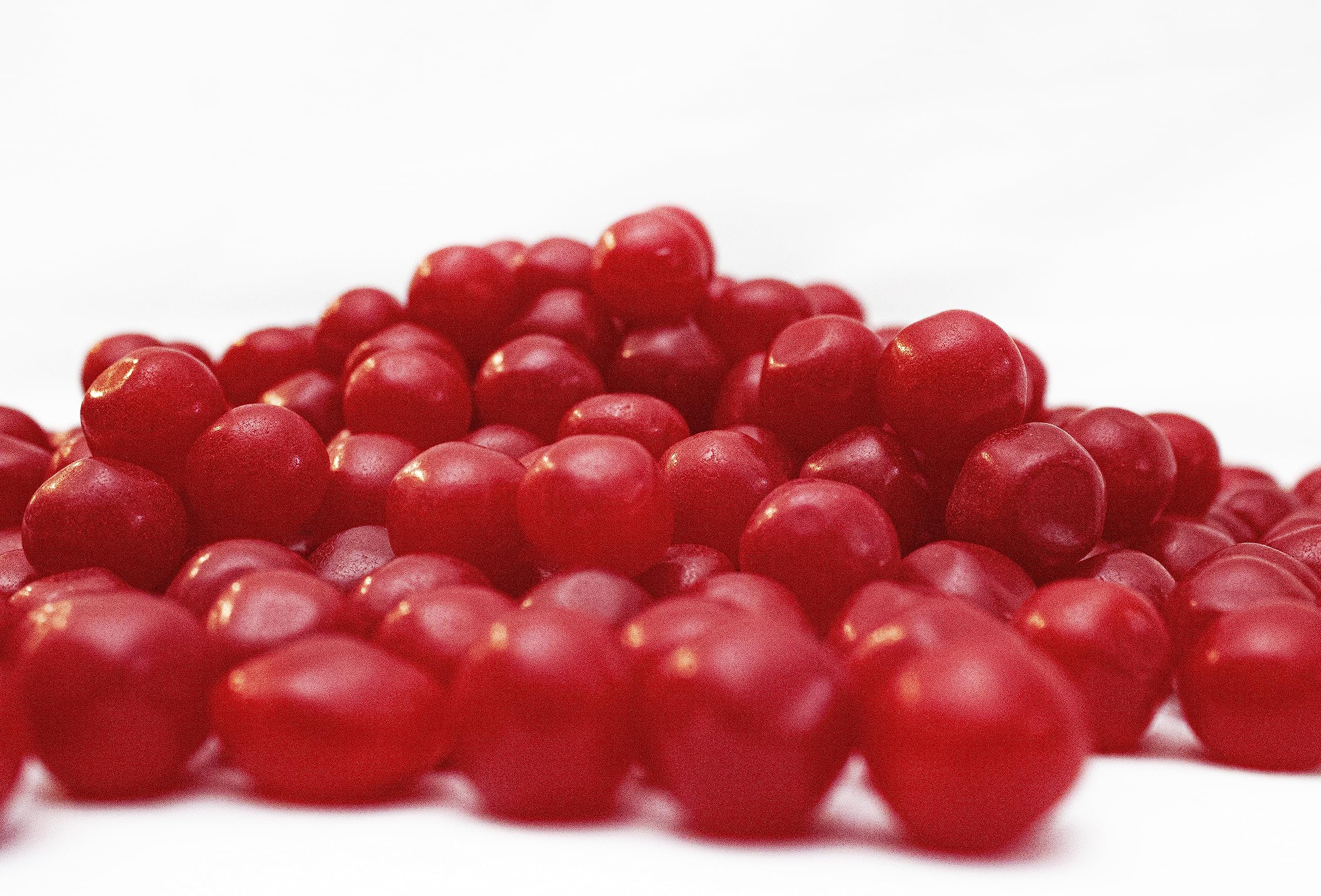 DM Sweets Cherry Sours candy closeup showing tangy flavor and glossy surface