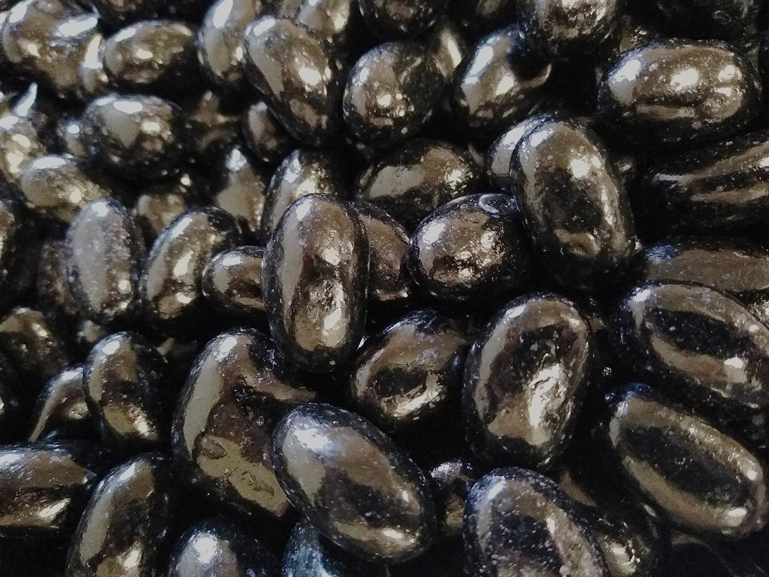 DM Sweets jumbo jelly beans close-up, glossy black licorice for bold snacking.
