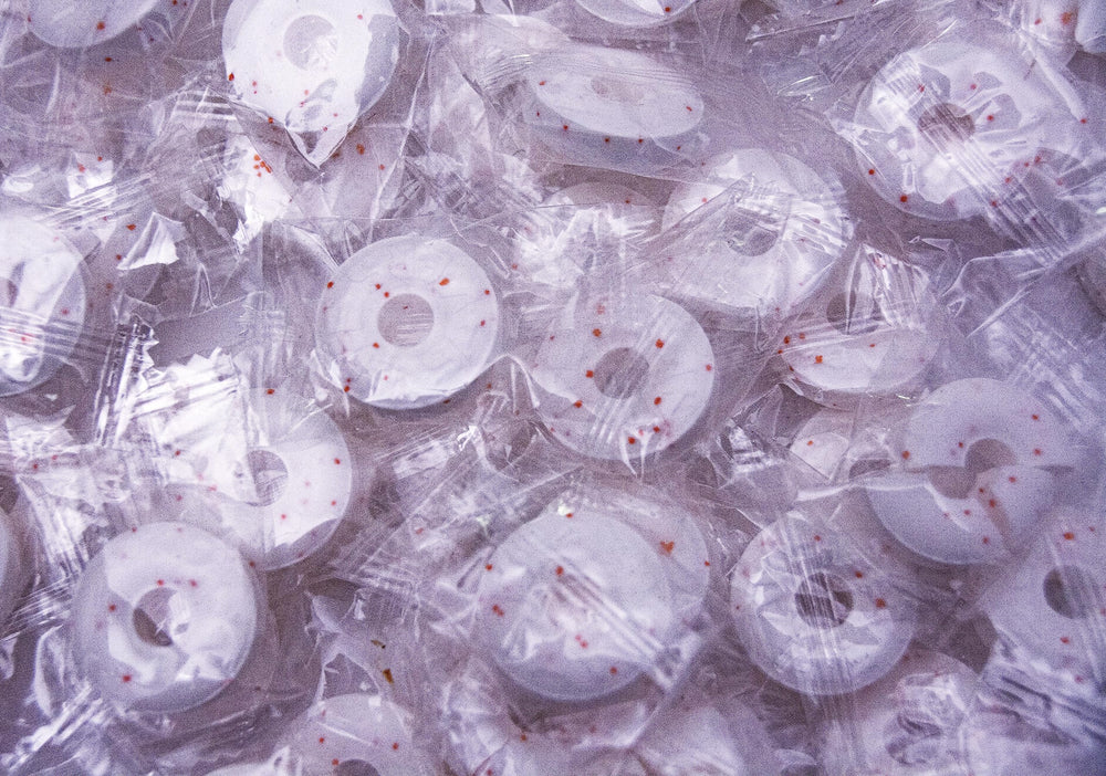 DM Sweets Orange Mints angled bulk view, easy to portion in bowls or baskets.