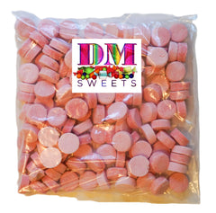 Close-up of pink wintergreen lozenge mint showing bright hue and crisp texture.
