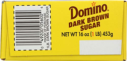 Domino Dark Brown Sugar measured with a spoon for recipes.
