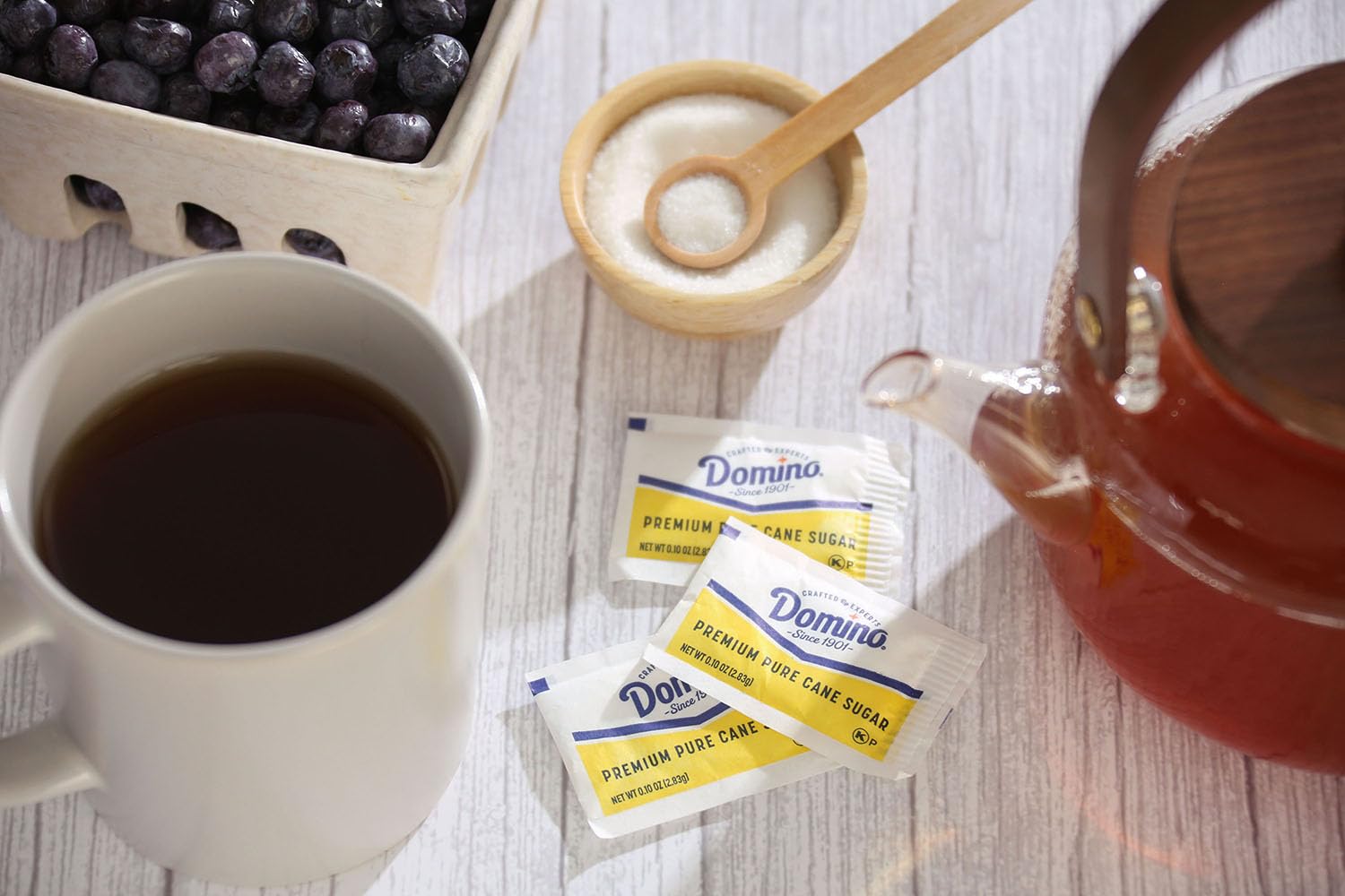 Domino sugar packets in a cafe setup showing convenient portion control.