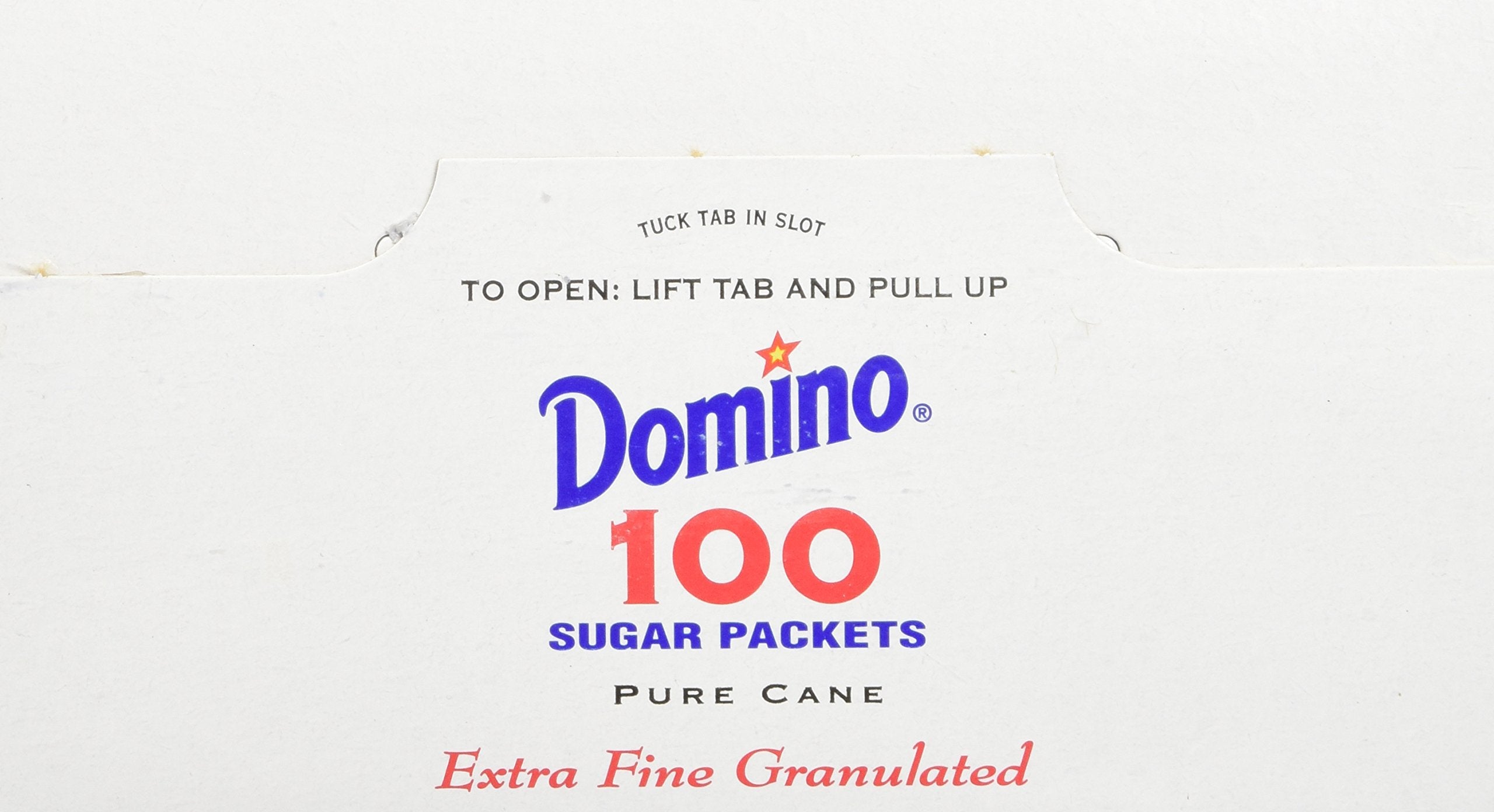 Domino sugar packets in an office breakroom for quick sugar during meetings.