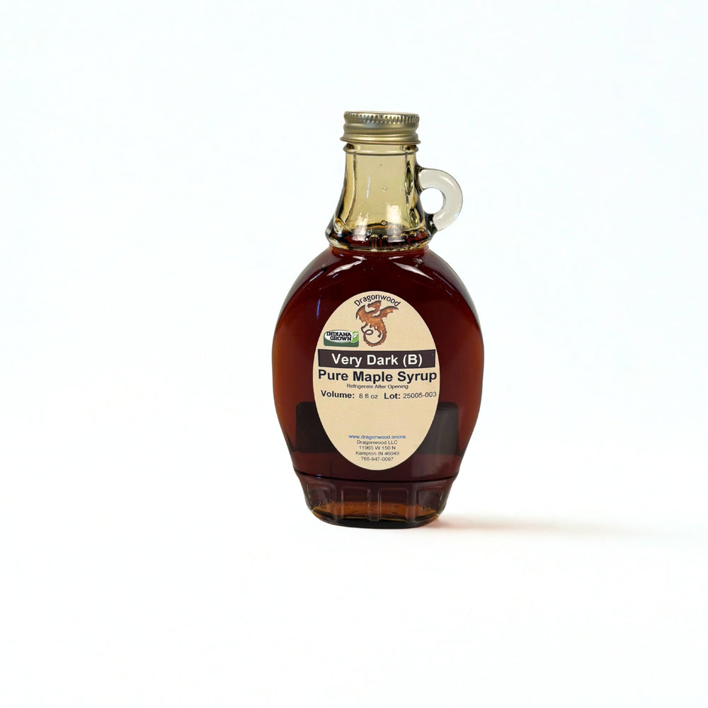 Dragonwood Pure Maple Syrup, very dark bottle pour, delivers bold maple flavor for cooking and toppings.