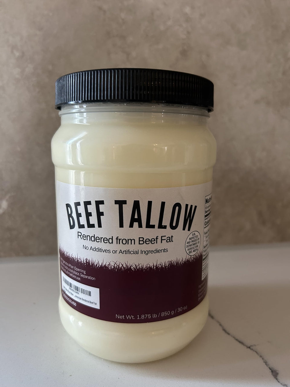 Drip Co beef tallow in fridge door for easy access