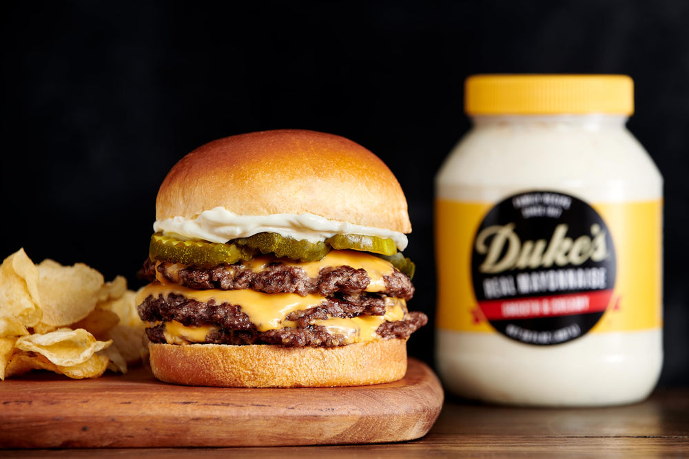 Duke's mayo spread on tomato sandwich for balanced flavor.