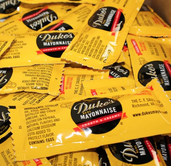 Close-up of Dukes sugar-free mayo packets highlighting convenient packaging for quick meals.