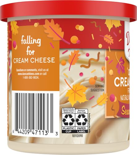 Duncan Hines Creamy Cream Cheese Frosting cupcakes with garnish and sprinkles.