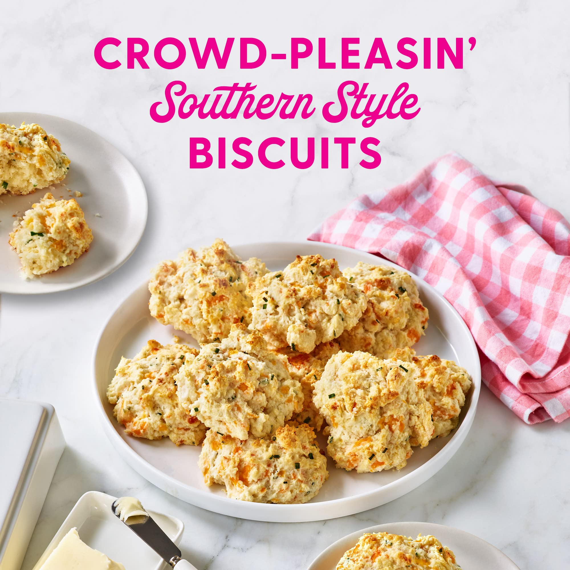Duncan Hines Dolly Parton's Biscuit Mix on a kitchen table with fresh ingredients.