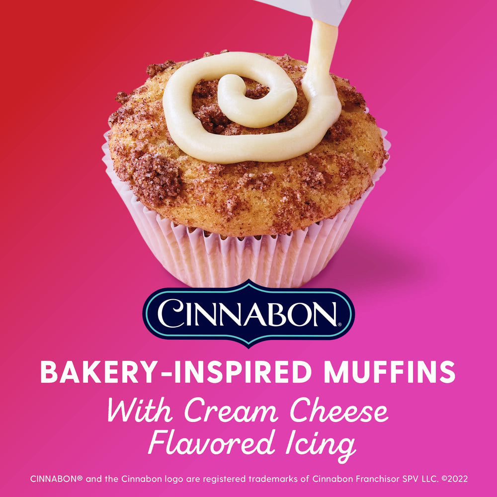 Duncan Hines Epic Cinnabon muffin batter being poured into tins for fluffy results.