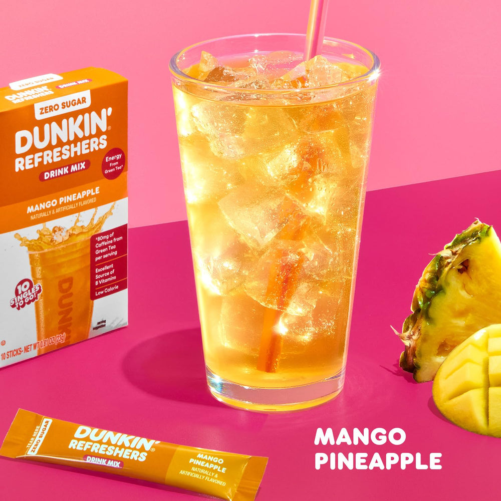 Dunkin Refreshers Mango Pineapple ready-to-mix sachet beside a chilled glass.