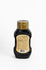 Label closeup of D'Vash Organic Date Syrup showing 100% dates and clean ingredients