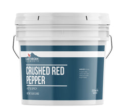 Earthborn Elements crushed red pepper flakes in a large bucket for versatile heat.