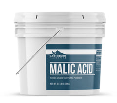Pouring Earthborn Elements malic acid powder into a recipe for flavoring.