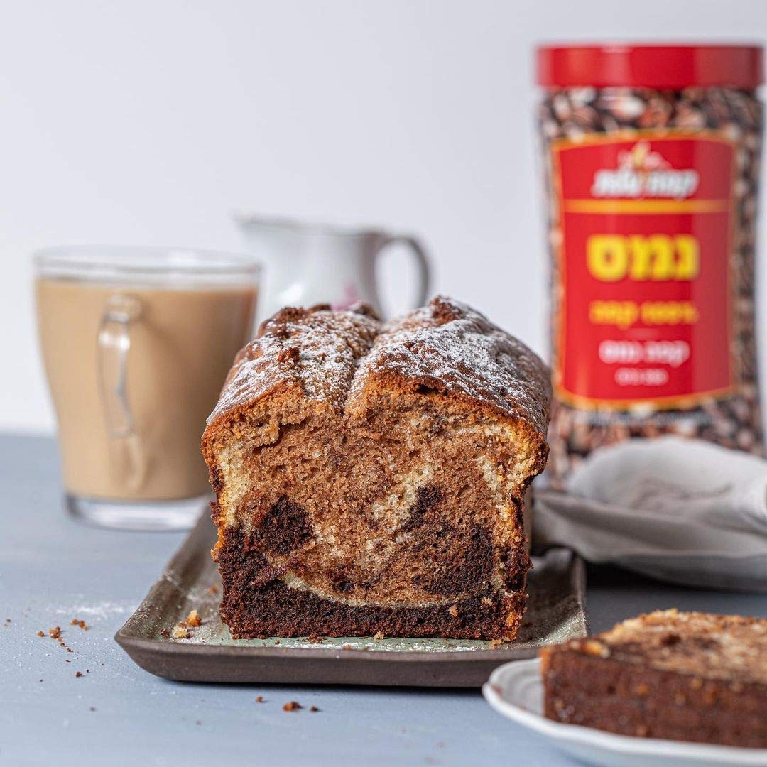 Steaming cup of Elite Instant Coffee, aromatic and inviting.