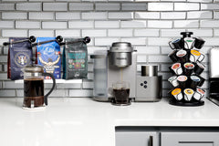 Ellis Coffee Presidential Light Roast pods beside a freshly brewed cup