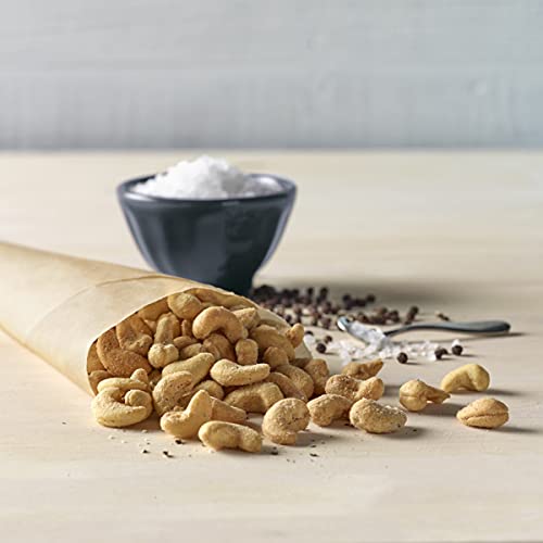 Emerald Salt and Pepper Cashews held in hand