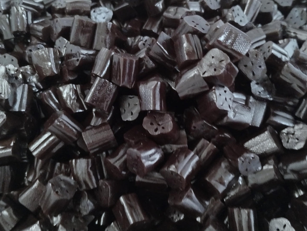 Emporium Candy licorice bites in hand, ready to enjoy