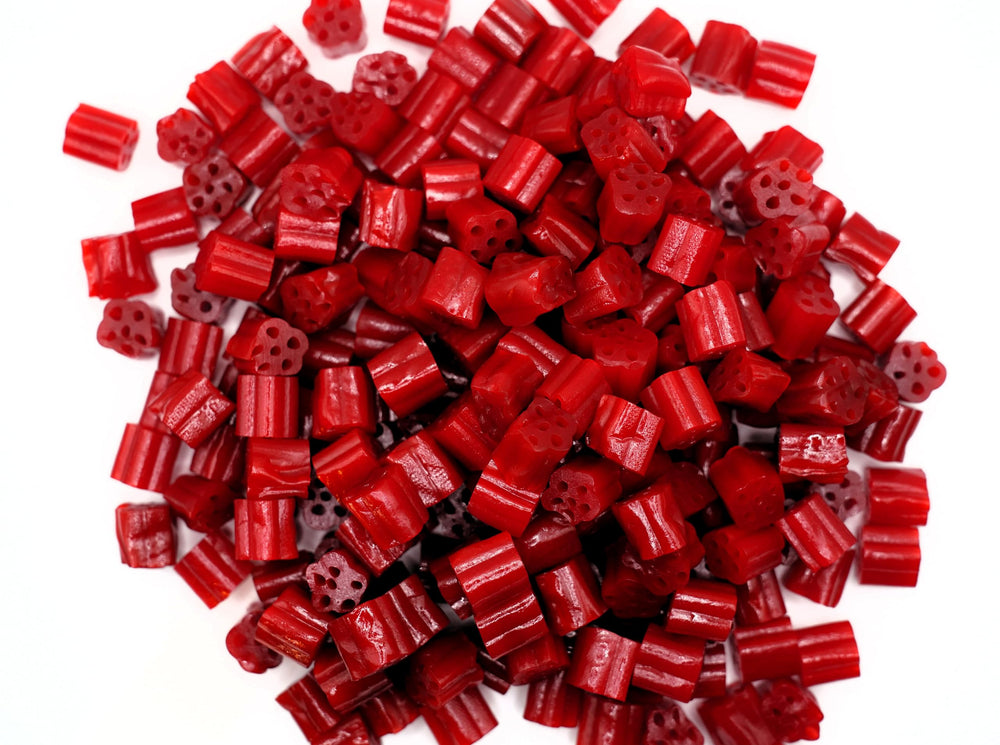 Emporium Candy Cherry Licorice Bites macro texture reveals the smooth surface and sheen.