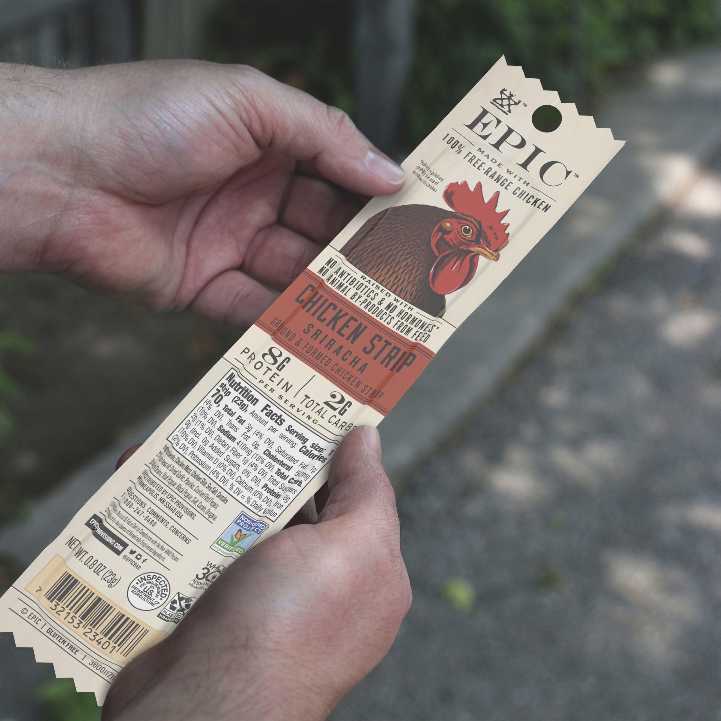 EPIC Sriracha Chicken Strip held in hand for on-the-go snacking