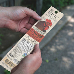 EPIC Sriracha Chicken Strip held in hand for on-the-go snacking