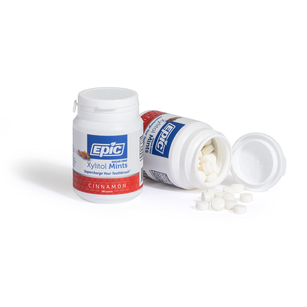 Epic Cinnamon Xylitol Mints shown on a desk for on-the-go freshness.