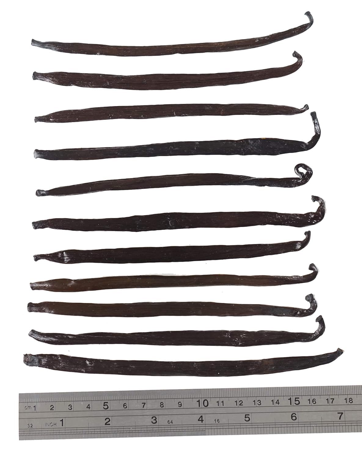 ESSENCE Vanilla beans close-up shows plump pods with glossy surface