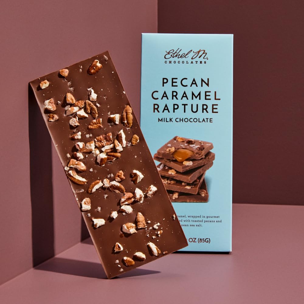 Close-up of Ethel M chocolate bar showing creamy filling and crunchy pecans.