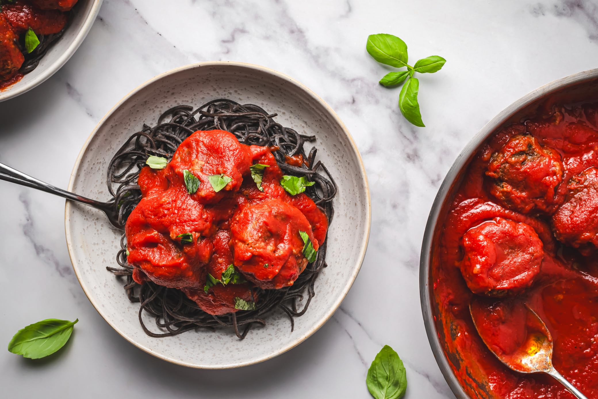 EXPLORE CUISINE Kitchen scene featuring black bean pasta.