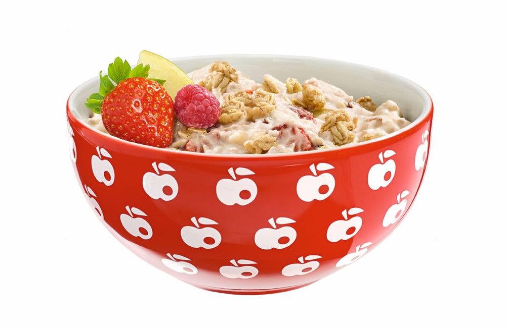 Pouring milk over Bircher Muesli for a fast satisfying breakfast