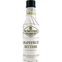 Fee Brothers Grapefruit Cocktail Bitters being poured into a glass to balance citrus flavors.