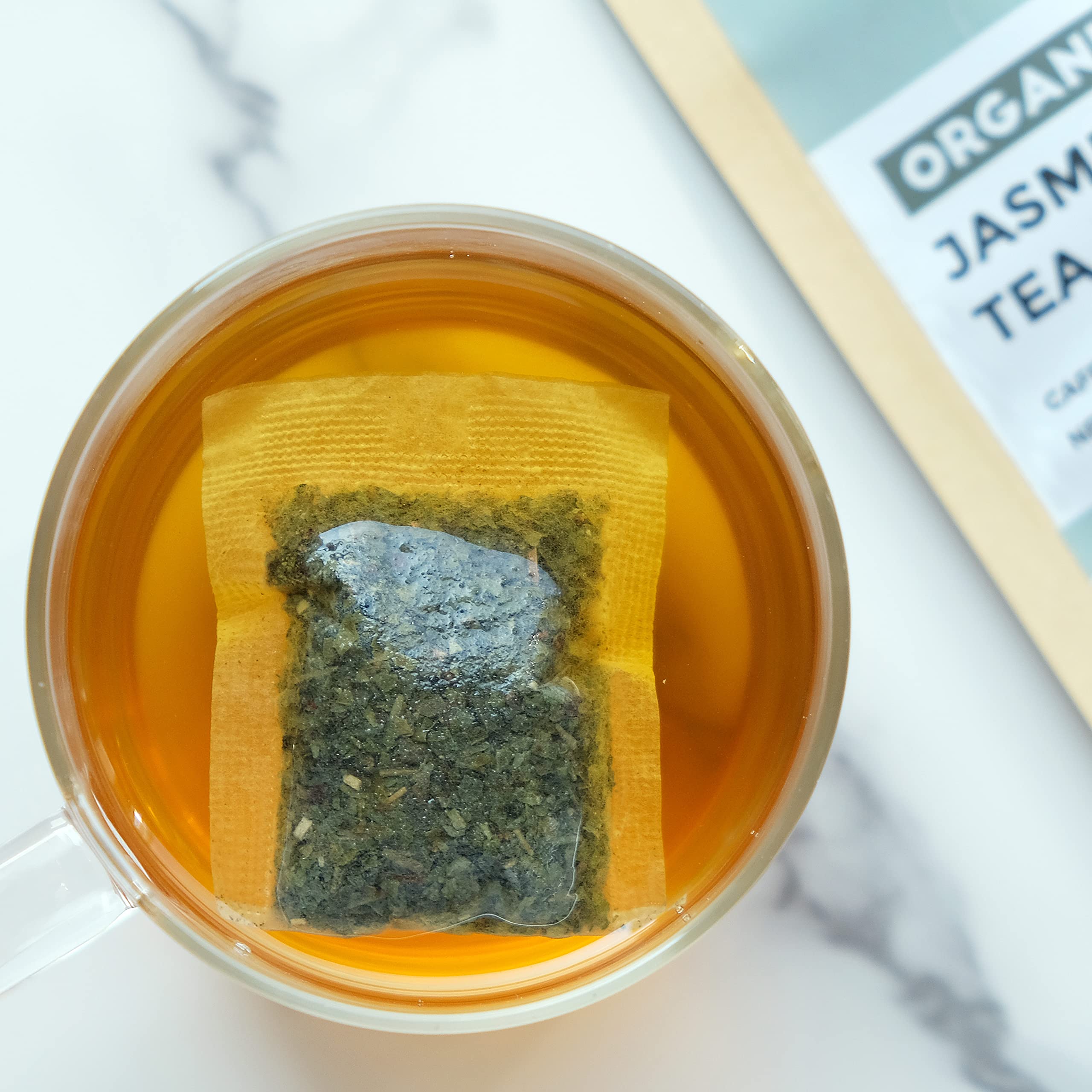 Fescha flower-scented tea bags close-up reveals delicate jasmine blossoms