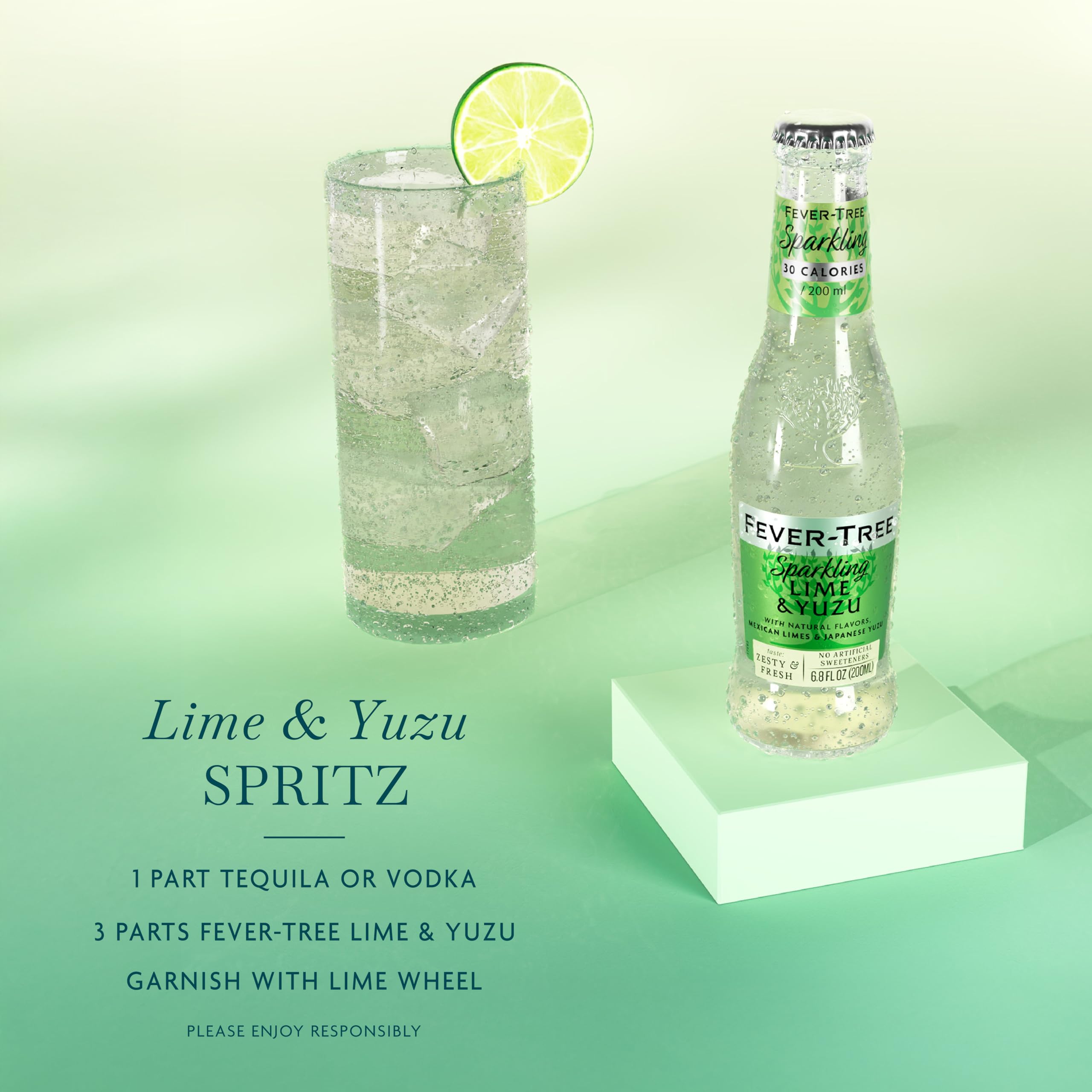 Glass with Fever-Tree Sparkling Yuzu & Lime and a lime garnish for vibrant cocktails.