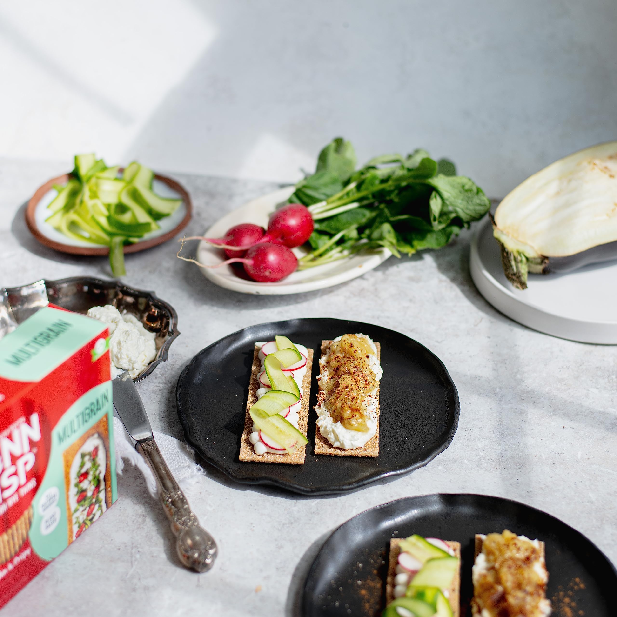 Finn Crisp Multigrain Crispbread on a charcuterie board, pairing with meats and spreads.