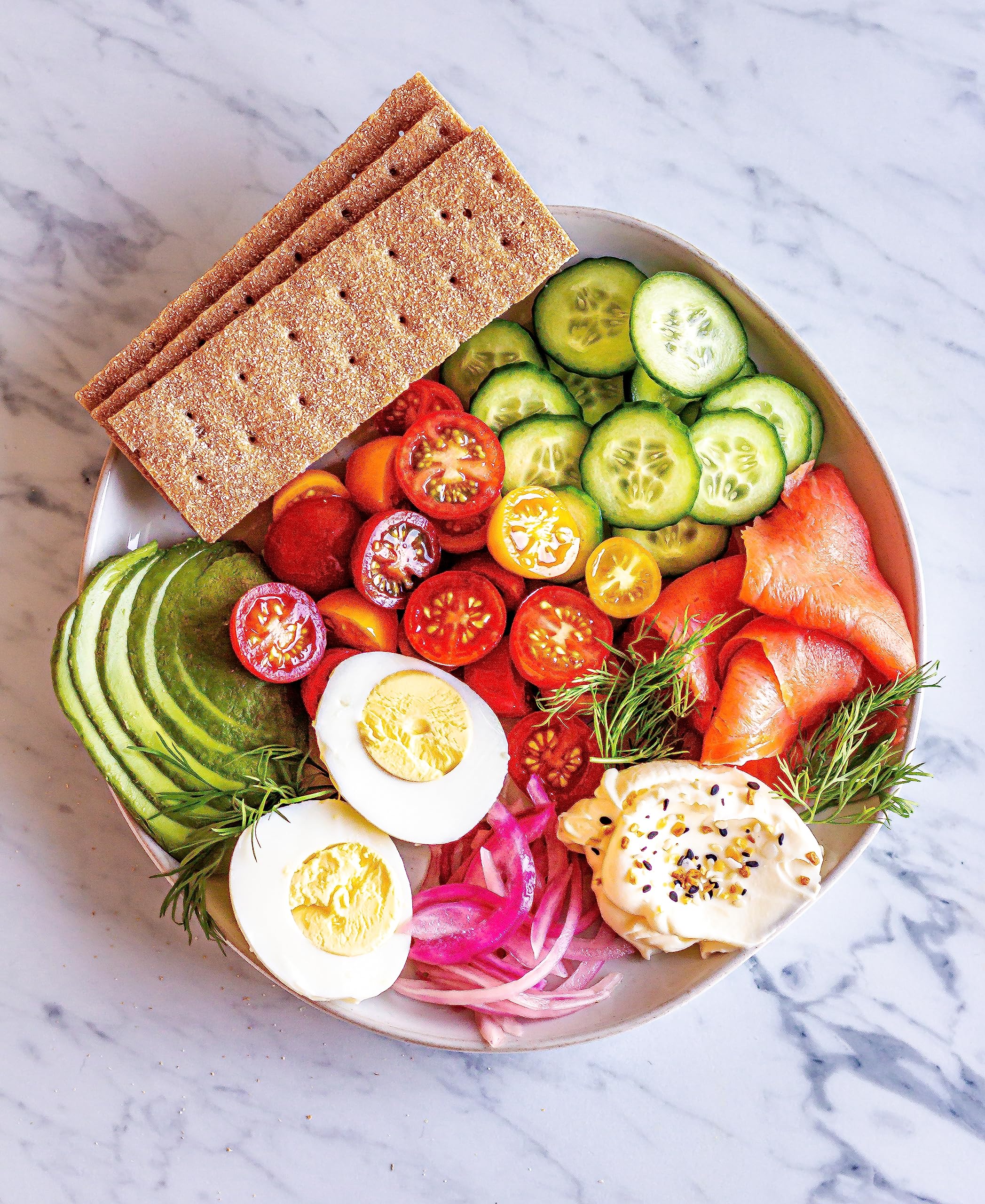 Finn Crisp Multigrain Crispbread topped with vegetables and cheese for a colorful snack.