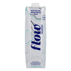 Flow alkaline spring water 1L being poured into glass for everyday use.