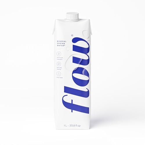 Flow Alkaline Spring Water pours into glass for refreshing hydration