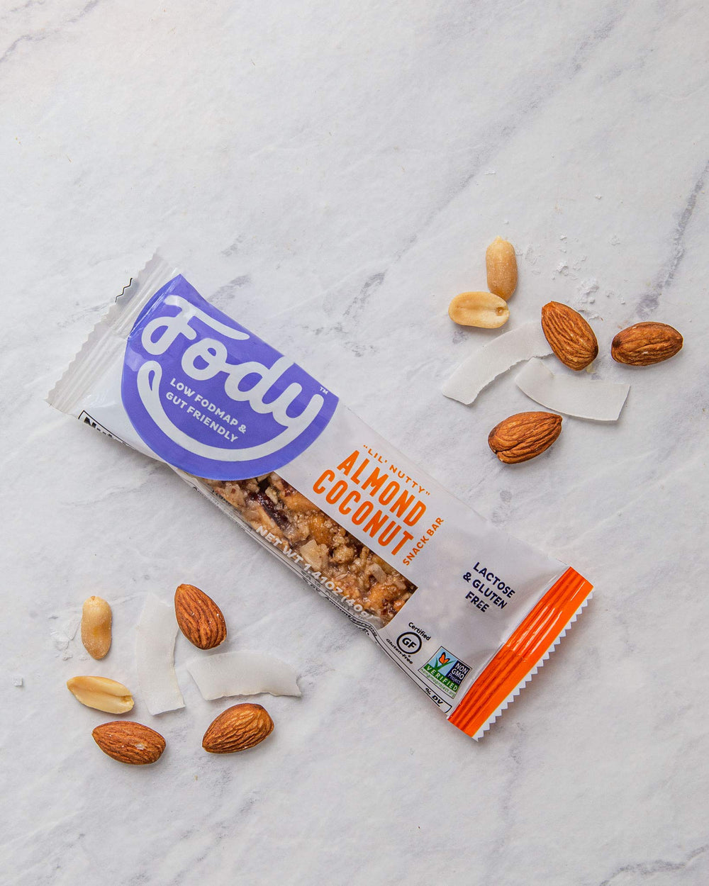 Fody Almond Coconut Snack Bars bite view highlighting chewy maple finish.