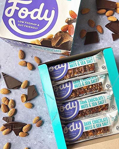 A hand holds a Fody bar for on-the-go snacking.