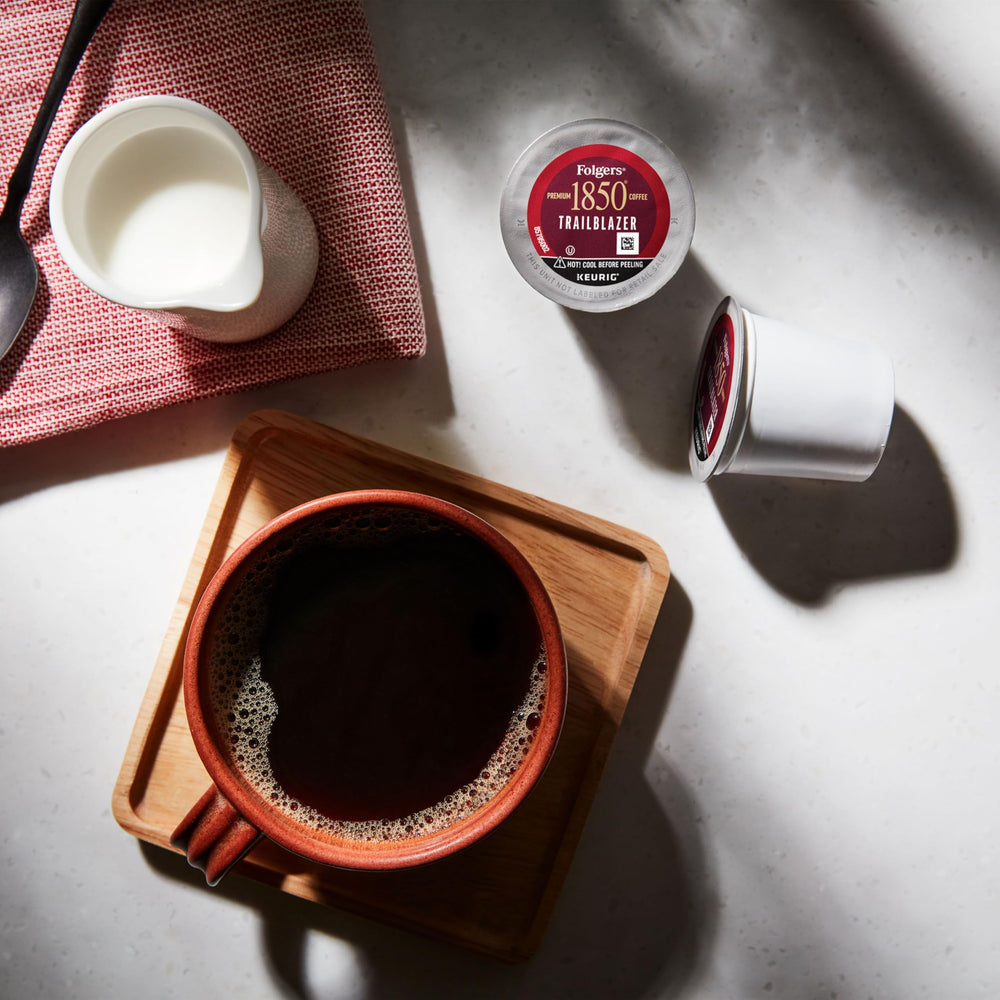 Folgers 1850 Trailblazer brewed cup steaming, signaling ready-to-drink convenience.