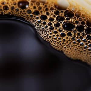 Close-up reveals color and aroma of Folgers decaf brewed cup.