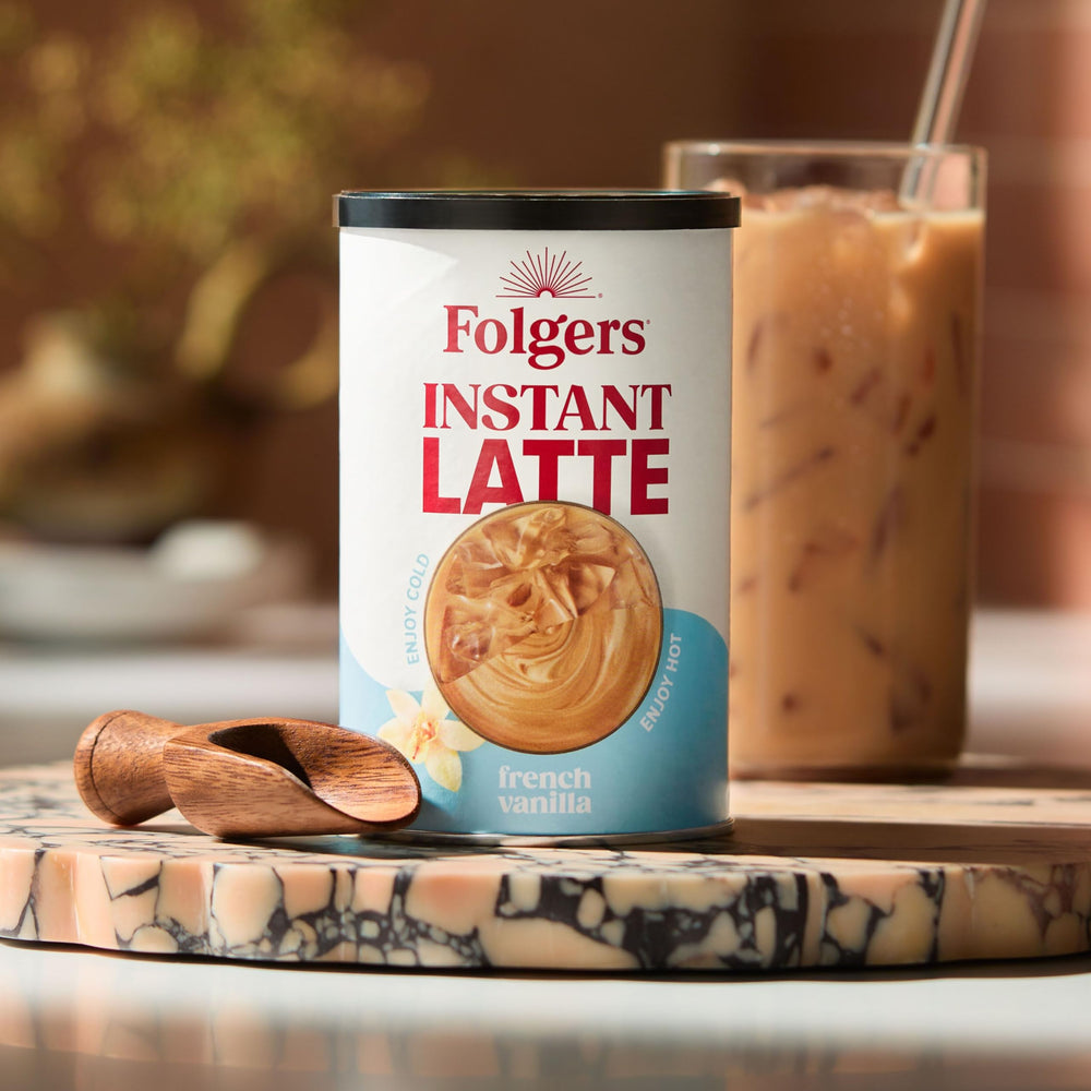 Pouring Folgers vanilla latte into a mug for tasting