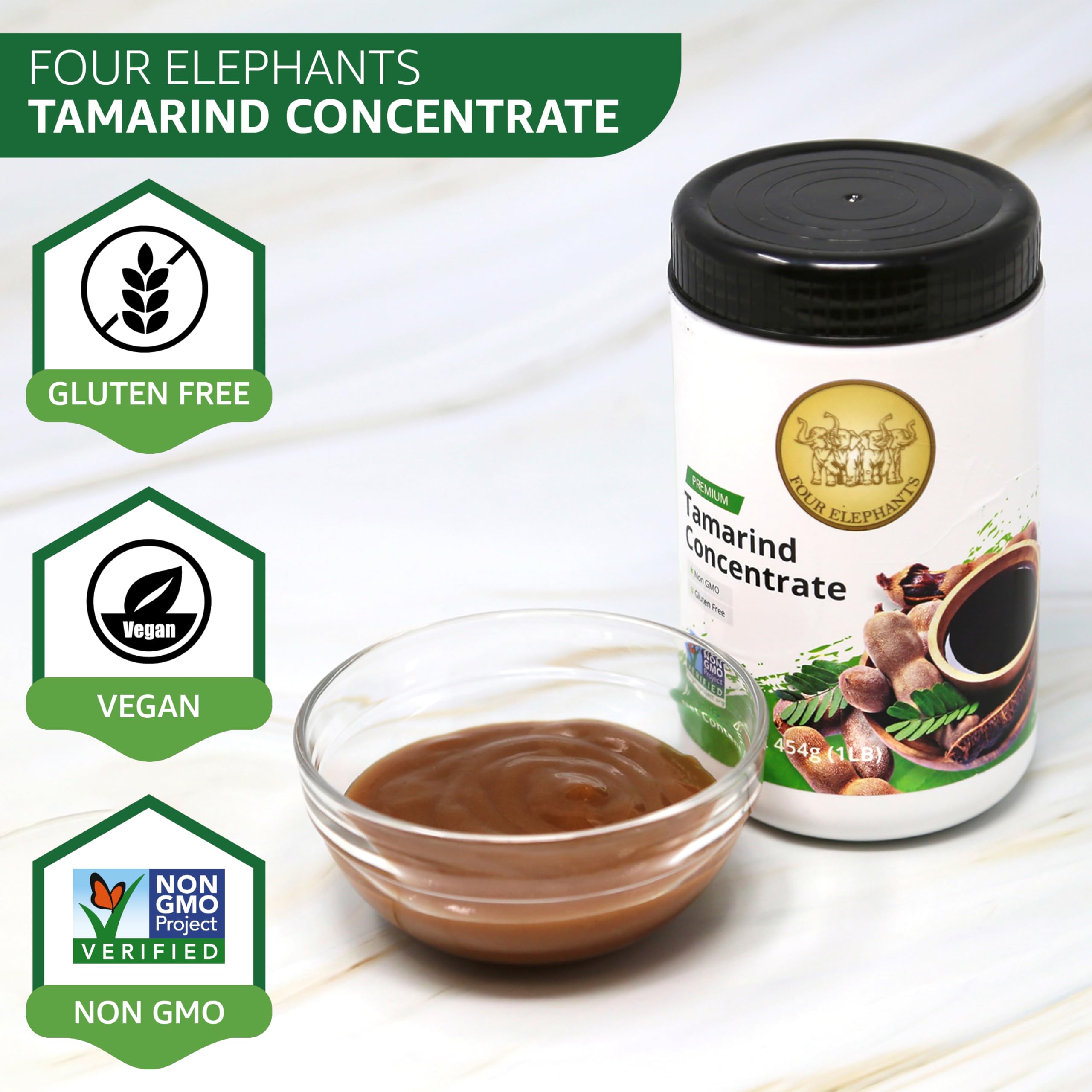 Pouring Four Elephants Tamarind Concentrate for tangy flavor addition.
