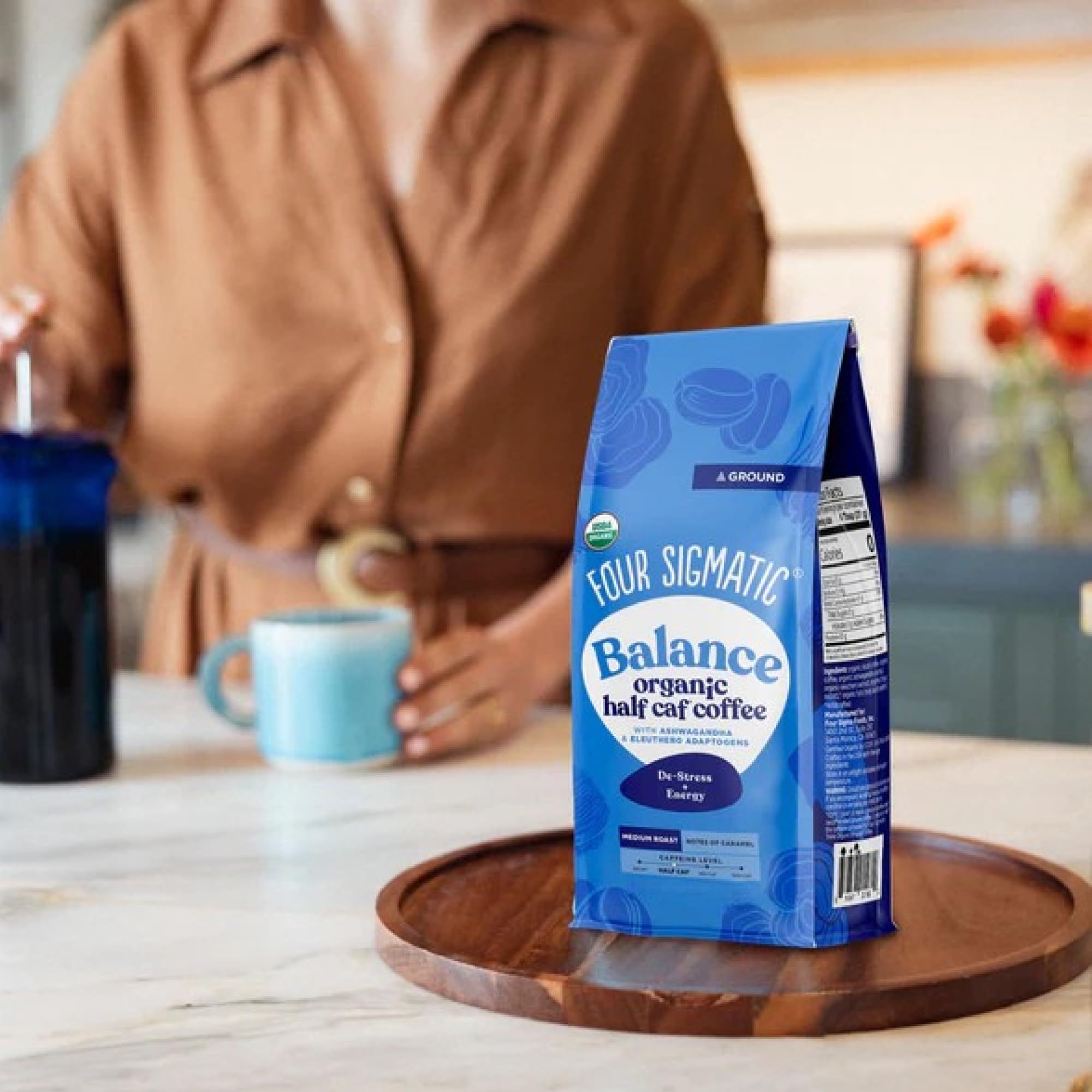 Four Sigmatic Tulsi leaves signaling soothing herbal notes.